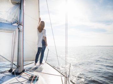 woman-staying-on-sailboat